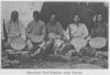 MEDICINE PIPE PRIESTS WITH DRUMS.